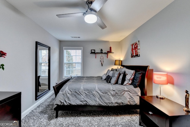 bedroom with baseboards, carpet, visible vents, and a ceiling fan