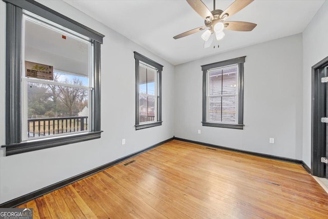 unfurnished room with ceiling fan and wood-type flooring