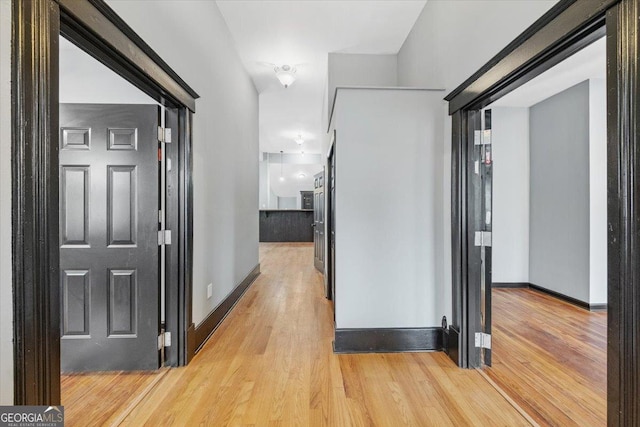 corridor with light wood-type flooring