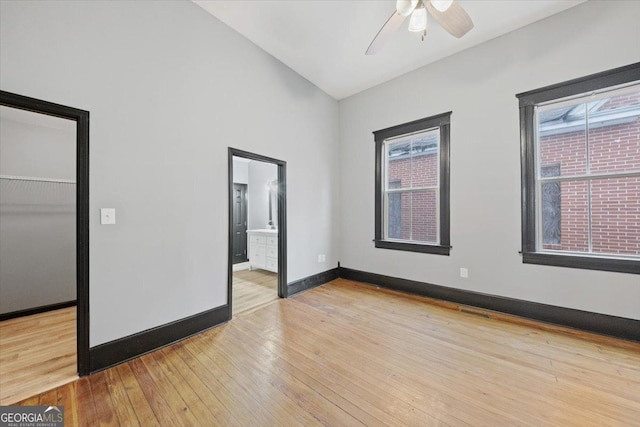 empty room with ceiling fan and light wood-type flooring