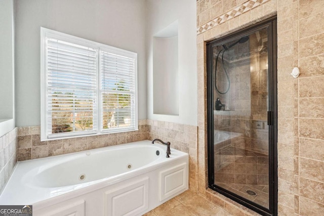 bathroom featuring independent shower and bath and tile patterned flooring