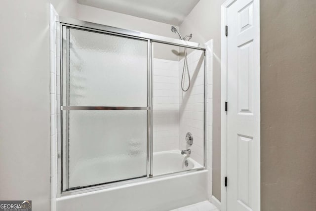 bathroom featuring shower / bath combination with glass door