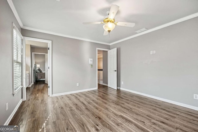 unfurnished bedroom with ceiling fan, dark hardwood / wood-style floors, and ornamental molding