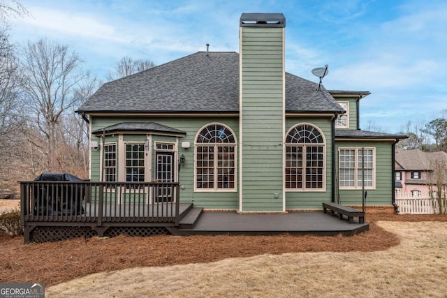 rear view of house with a wooden deck