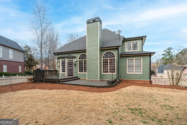 back of house with a yard and a wooden deck