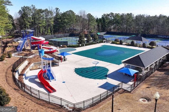 view of swimming pool featuring a playground