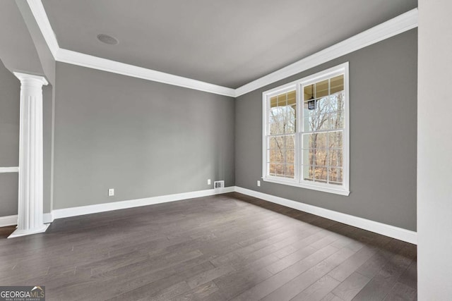 spare room with dark hardwood / wood-style flooring, ornamental molding, and ornate columns