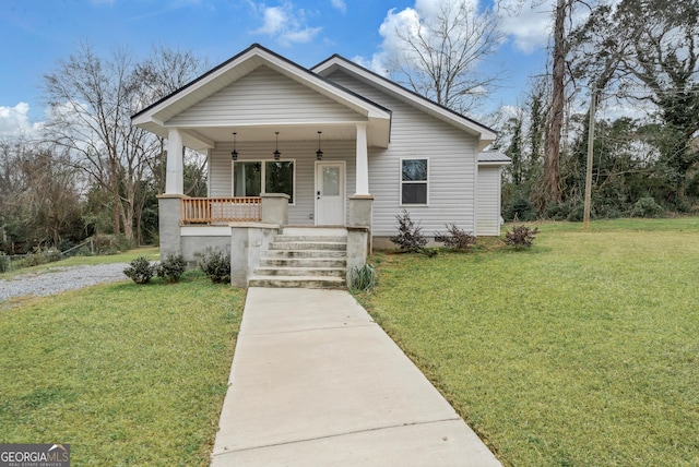 bungalow-style house with covered porch and a front lawn