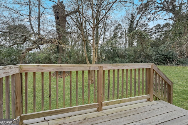 wooden deck featuring a yard