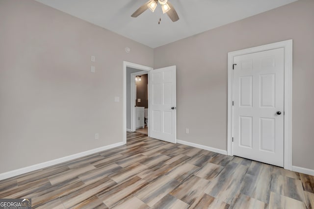 unfurnished bedroom featuring ceiling fan and hardwood / wood-style floors