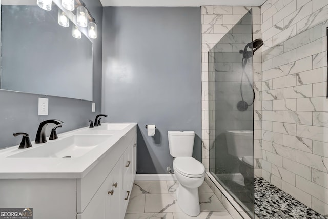 bathroom featuring vanity, toilet, and tiled shower