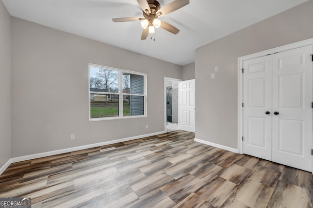 unfurnished bedroom featuring ceiling fan, light hardwood / wood-style floors, and a closet