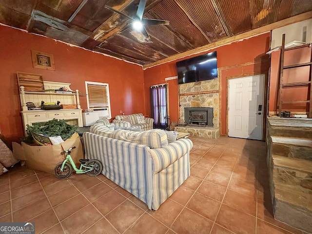 tiled living area featuring ceiling fan and wood ceiling