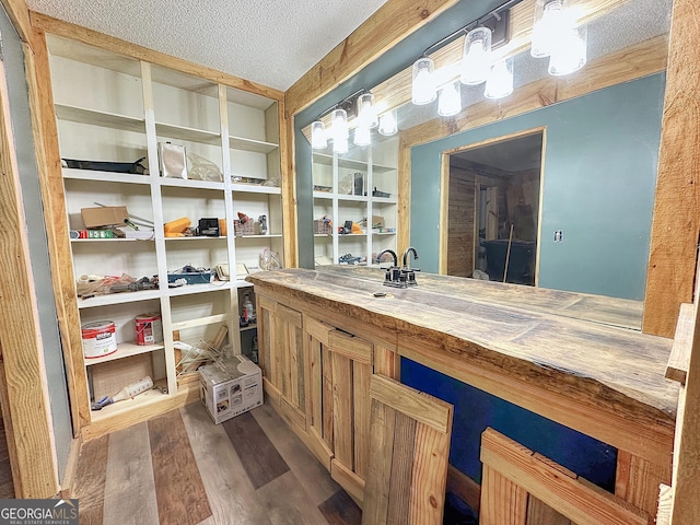 bathroom featuring vanity, a textured ceiling, and wood finished floors