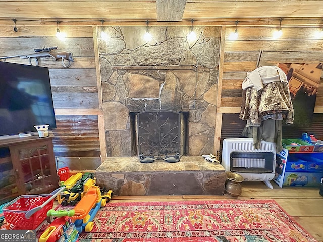 living area featuring a fireplace and heating unit