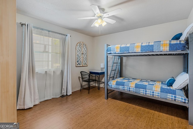 bedroom featuring wood-type flooring and ceiling fan