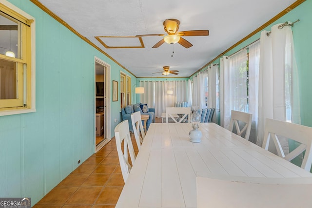 dining space with light tile patterned flooring, ornamental molding, and ceiling fan