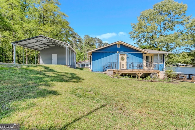 view of front facade with a front yard, a carport, and a deck