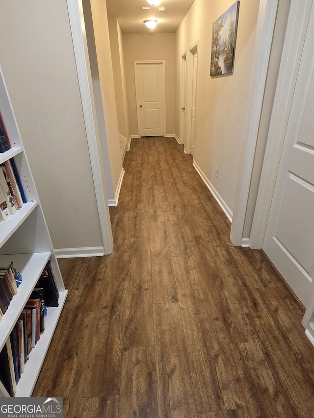 hall with dark wood-type flooring