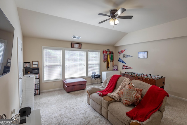 living room with vaulted ceiling, ceiling fan, and light colored carpet