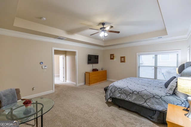 bedroom featuring a raised ceiling, ceiling fan, crown molding, and light colored carpet