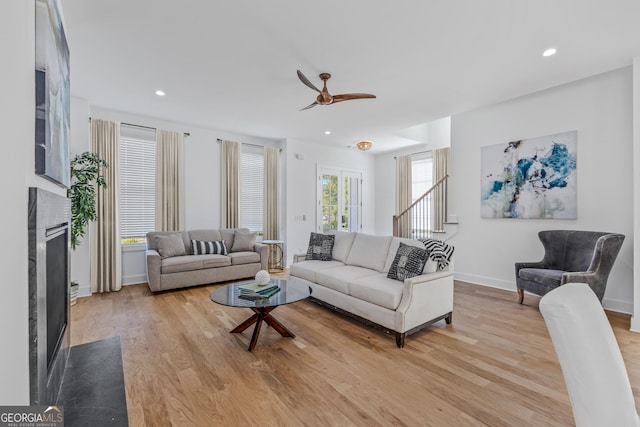 living room with recessed lighting, light wood-style floors, and a fireplace