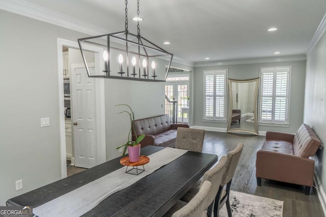 dining room with dark wood-type flooring and crown molding