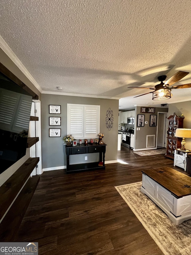 living room with ornamental molding, dark hardwood / wood-style floors, ceiling fan, and a textured ceiling