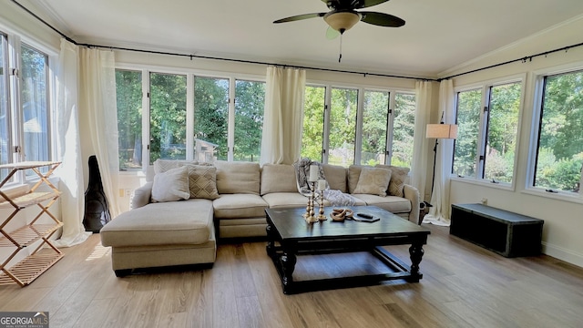 sunroom / solarium featuring ceiling fan and vaulted ceiling