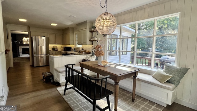 dining space featuring dark hardwood / wood-style floors and a chandelier