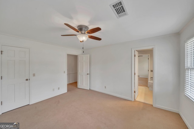 1706 Murphy Ln, Dublin, GA 31021 - unfurnished bedroom featuring carpet floors, crown molding, ensuite bathroom, and ceiling fan