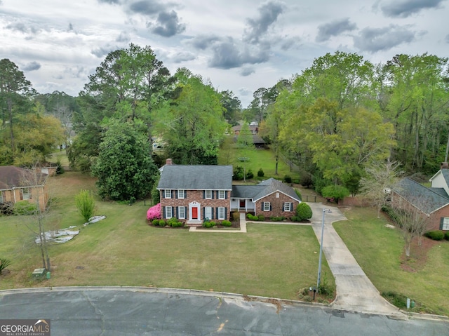1706 Murphy Ln, Dublin, GA 31021 - view of front of home with a chimney, a front yard, driveway, and brick siding