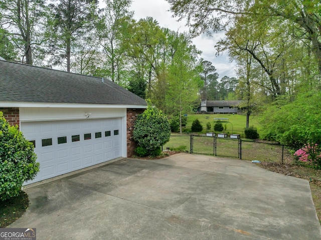 1706 Murphy Ln, Dublin, GA 31021 - garage with a gate and view of scattered trees