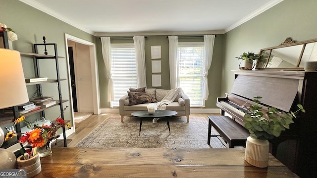 sitting room featuring crown molding and light hardwood / wood-style flooring