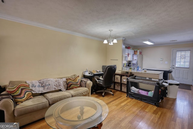 office space with light wood-type flooring, crown molding, a chandelier, and a textured ceiling