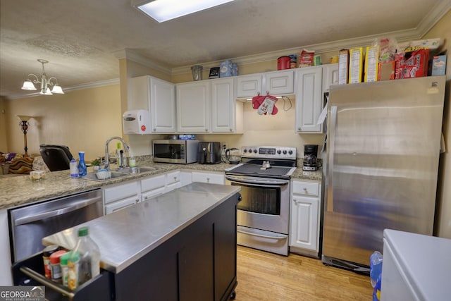 kitchen featuring appliances with stainless steel finishes, light wood-style flooring, white cabinetry, and crown molding