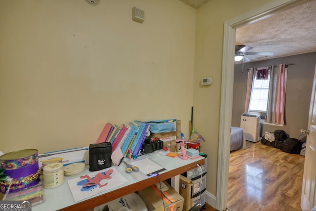 office space with ceiling fan and wood finished floors