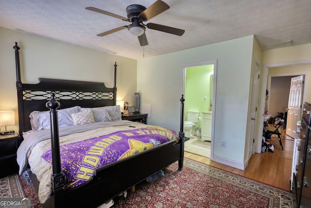 bedroom featuring baseboards, a ceiling fan, connected bathroom, wood finished floors, and a textured ceiling