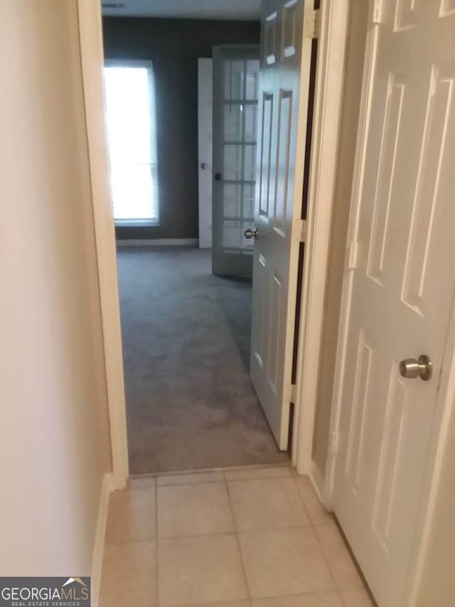 corridor with light tile patterned flooring