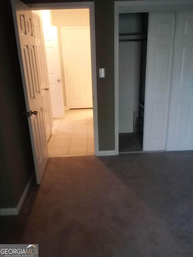 unfurnished bedroom featuring a closet and carpet