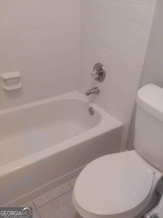 bathroom featuring shower / bath combination, tile patterned floors, and toilet