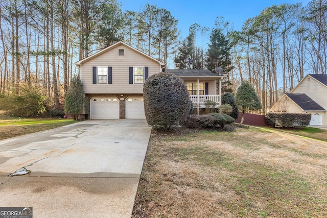 split level home featuring driveway, a garage, a front lawn, and brick siding