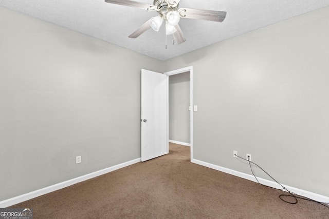 carpeted empty room featuring a textured ceiling and ceiling fan