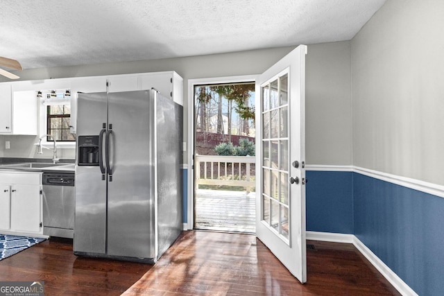 kitchen with white cabinetry, appliances with stainless steel finishes, sink, and dark wood-type flooring