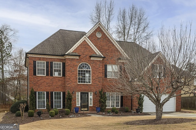 view of front of property with concrete driveway, brick siding, an attached garage, and roof with shingles