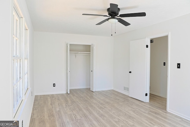 unfurnished bedroom with light wood-style floors, baseboards, visible vents, and a closet