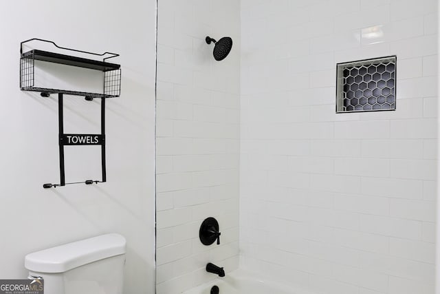 bathroom with shower / bathing tub combination and toilet