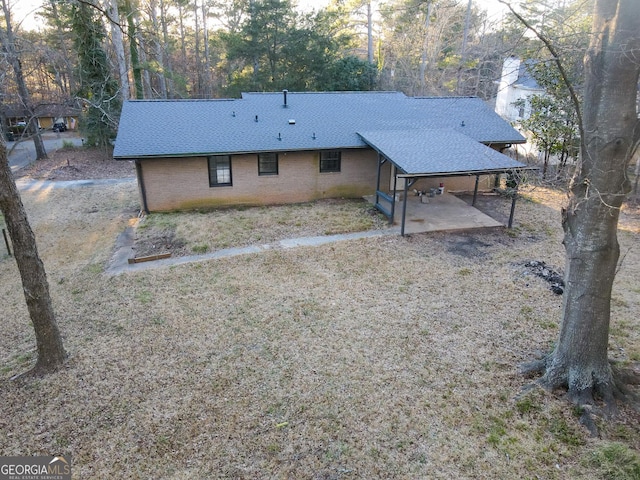 exterior space featuring a patio area and roof with shingles