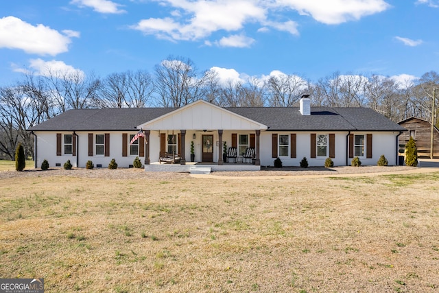 ranch-style home with covered porch and a front yard