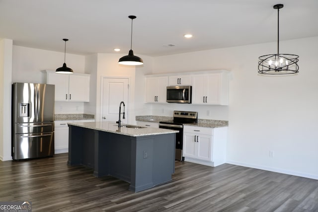 kitchen with stainless steel appliances, white cabinetry, and a sink